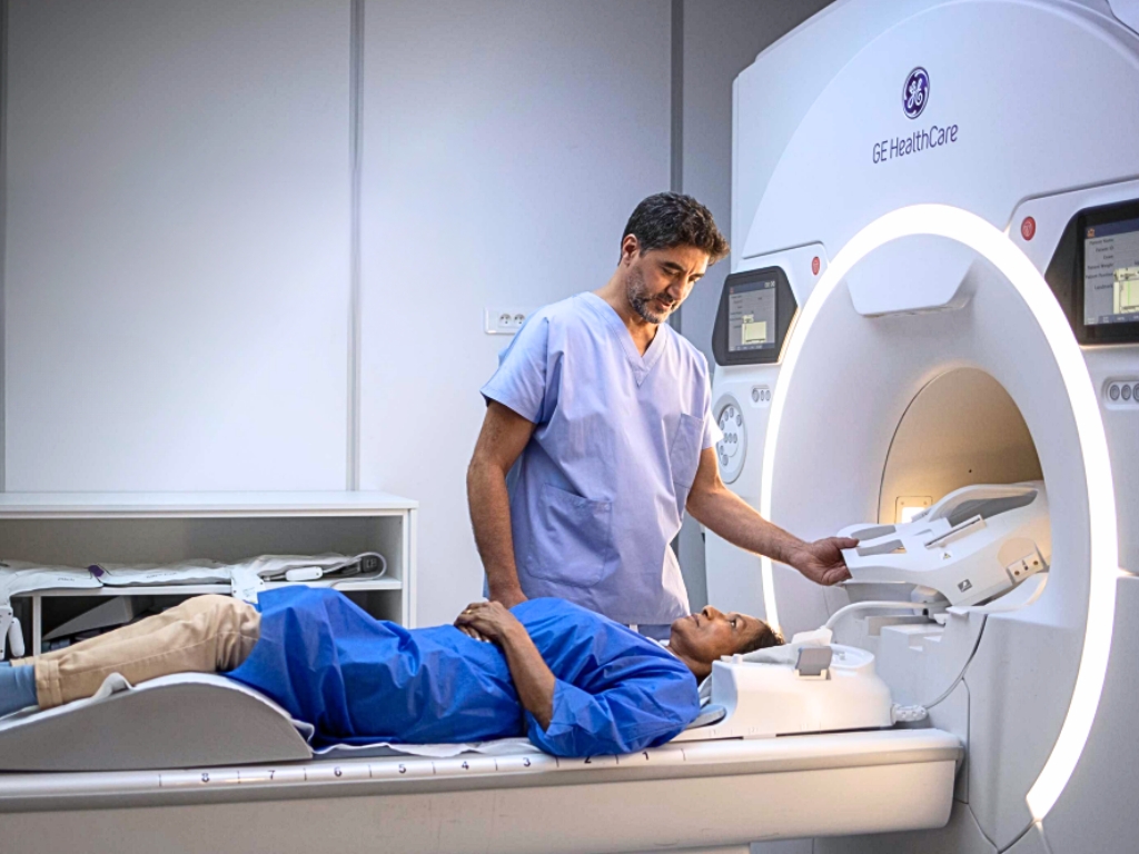 Médico ayuda a paciente en máquina de resonancia